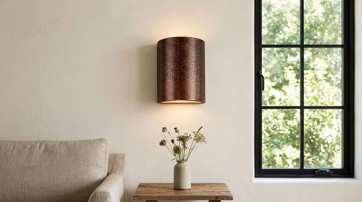 Hammered copper cylinder wall sconce with warm up and down lighting — view 1
