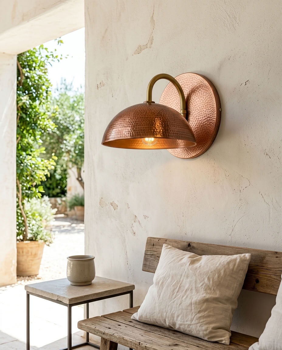 Hammered copper dome wall sconce with curved arm and warm ambient light — view 3