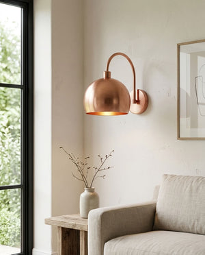 Modern smooth copper dome wall sconce with arched arm and warm light — view 1